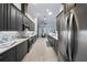 Modern kitchen featuring sleek dark cabinetry, stainless steel appliances, and an open layout at 3281 Saloman Ln, Clermont, FL 34711