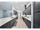 Modern kitchen with sleek dark cabinetry, stainless steel appliances, and stylish backsplash at 3281 Saloman Ln, Clermont, FL 34711