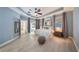 Spacious main bedroom with tray ceiling, ceiling fan, light gray walls, and access to the outdoor patio at 3281 Saloman Ln, Clermont, FL 34711