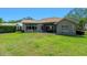 Backyard with a green lawn, patio with furniture, and exterior view of home at 3317 Oakmont Ter, Longwood, FL 32779