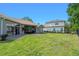 Spacious backyard featuring a well-maintained lawn, ideal for Gathering gatherings and outdoor enjoyment at 3317 Oakmont Ter, Longwood, FL 32779