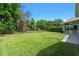 This backyard features a green lawn, trees, and privacy fence at 3317 Oakmont Ter, Longwood, FL 32779