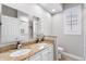 Bathroom with dual sinks, granite countertops, and walk-in shower at 3317 Oakmont Ter, Longwood, FL 32779