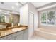 Bright bathroom featuring granite countertops, a bathtub, a glass shower, and tiled floors at 3317 Oakmont Ter, Longwood, FL 32779