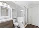 This bathroom features a single sink vanity, glass shower, and wood flooring at 3317 Oakmont Ter, Longwood, FL 32779