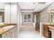 Elegant bathroom with a tub, a glass shower, and double sinks with granite countertops at 3317 Oakmont Ter, Longwood, FL 32779