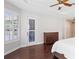 Bedroom featuring hardwood floors, a tray ceiling, plantation shutters, and access to the backyard at 3317 Oakmont Ter, Longwood, FL 32779