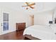 Bedroom featuring hardwood floors, a tray ceiling, plantation shutters, and access to the backyard at 3317 Oakmont Ter, Longwood, FL 32779
