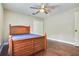 Bedroom with dark floors, ceiling fan, bright window and closet at 3317 Oakmont Ter, Longwood, FL 32779