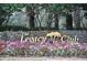 Legacy Club sign displayed amidst lush greenery and colorful flowers at 3317 Oakmont Ter, Longwood, FL 32779