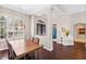 Spacious formal dining room with hardwood floors, a modern light fixture, and view into other rooms at 3317 Oakmont Ter, Longwood, FL 32779