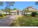 Beautiful single Gathering home boasting a paver driveway, tan stucco, and meticulously manicured landscaping at 3317 Oakmont Ter, Longwood, FL 32779