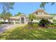 Stunning single Gathering home boasting a paver driveway, tan stucco, and meticulously manicured landscaping at 3317 Oakmont Ter, Longwood, FL 32779