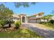 Charming single Gathering home featuring a three-car garage, tan stucco, and a paver driveway at 3317 Oakmont Ter, Longwood, FL 32779