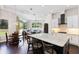 Modern kitchen with large island, seating, and open layout to a bright living room, creating a welcoming atmosphere at 3317 Oakmont Ter, Longwood, FL 32779