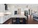 Well-lit kitchen with white cabinets, stainless steel appliances, and a large center island at 3317 Oakmont Ter, Longwood, FL 32779