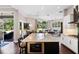 Modern kitchen with large island, breakfast bar, stainless steel appliances, and seamless transition to living spaces at 3317 Oakmont Ter, Longwood, FL 32779