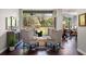 Bright living room with backyard views, stylish gray chairs, and dark wood floors, creating a welcoming atmosphere at 3317 Oakmont Ter, Longwood, FL 32779