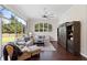 Living room with large windows and a decorative barn wood entertainment center at 3317 Oakmont Ter, Longwood, FL 32779