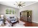 Comfortable living room featuring hardwood floors, a large window, and a rustic entertainment center at 3317 Oakmont Ter, Longwood, FL 32779