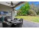 This patio is covered and features an outdoor grill, furniture, and backyard views at 3317 Oakmont Ter, Longwood, FL 32779