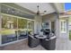 Covered patio with outdoor furniture, grill, TV, and backyard views at 3317 Oakmont Ter, Longwood, FL 32779