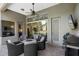 The covered patio features outdoor seating, a grill, a ceiling fan, and backyard views at 3317 Oakmont Ter, Longwood, FL 32779