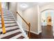 Beautiful staircase with dark wood treads and white risers and an entry view at 3317 Oakmont Ter, Longwood, FL 32779