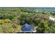 Aerial shot of a blue home nestled among lush trees, showcasing the spacious backyard at 34 Jackson Cir, Winter Springs, FL 32708