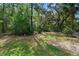 Lush backyard featuring mature trees and landscaping, offering a private outdoor space at 34 Jackson Cir, Winter Springs, FL 32708