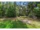 Lush backyard featuring mature trees and landscaping, offering a private outdoor space at 34 Jackson Cir, Winter Springs, FL 32708