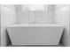 Luxurious bathroom showcasing a freestanding tub and a chrome faucet, set against a backdrop of marble-like tiled walls at 34 Jackson Cir, Winter Springs, FL 32708