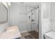 Modern bathroom featuring a glass shower with a pebble floor and a sleek vanity with marble countertop at 34 Jackson Cir, Winter Springs, FL 32708