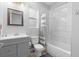 A neutral-toned bathroom with a shower-tub, toilet, vanity and ample countertop space at 34 Jackson Cir, Winter Springs, FL 32708