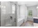 Elegant bathroom featuring a freestanding tub, glass-enclosed shower, and vanity with sink at 34 Jackson Cir, Winter Springs, FL 32708