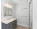 Bright bathroom showcases gray vanity with a marble countertop and a glass-enclosed shower at 34 Jackson Cir, Winter Springs, FL 32708