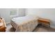 Simple bedroom featuring a bed and a wooden nightstand with ample natural light at 34 Jackson Cir, Winter Springs, FL 32708