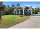 Charming two-story home featuring a columned front porch, landscaping, and a driveway at 34 Jackson Cir, Winter Springs, FL 32708