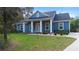 Charming blue home featuring a covered front porch and well-manicured lawn, perfect for curb appeal at 34 Jackson Cir, Winter Springs, FL 32708