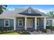 Inviting blue home with a covered front porch and white trim, creating a welcoming entrance at 34 Jackson Cir, Winter Springs, FL 32708