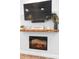 Stylish fireplace with a rustic mantel, a flat screen TV, and modern design elements adding warmth to the room at 34 Jackson Cir, Winter Springs, FL 32708