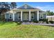 Charming home featuring a covered porch with white columns and a well-maintained lawn at 34 Jackson Cir, Winter Springs, FL 32708