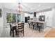 Bright kitchen with stainless steel appliances, an island with seating, and a dining table, ideal for entertaining at 34 Jackson Cir, Winter Springs, FL 32708