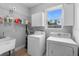 Well-lit laundry room with washer, dryer, and ample storage cabinets at 34 Jackson Cir, Winter Springs, FL 32708