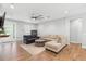 Spacious living room with hardwood floors, a modern ceiling fan, and neutral decor creating an inviting space at 34 Jackson Cir, Winter Springs, FL 32708