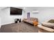 Cozy living room featuring a large TV, futon, and comfortable seating area at 34 Jackson Cir, Winter Springs, FL 32708