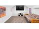 Living room features a futon, TV, and movie poster, with a casual and inviting atmosphere at 34 Jackson Cir, Winter Springs, FL 32708