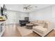 Bright living room featuring hardwood floors, neutral decor, and modern ceiling fan, creating a cozy atmosphere at 34 Jackson Cir, Winter Springs, FL 32708
