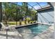 Relaxing pool with a serene backyard view and screened-in enclosure at 34 Jackson Cir, Winter Springs, FL 32708