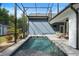 Inviting pool featuring a screened-in enclosure and outdoor dining area at 34 Jackson Cir, Winter Springs, FL 32708